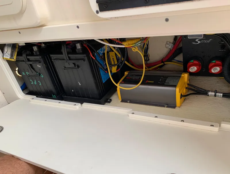 Slide: The Image of Battery compartment of a 2016 Scout 255 LXF boat with wiring and charger. - 20