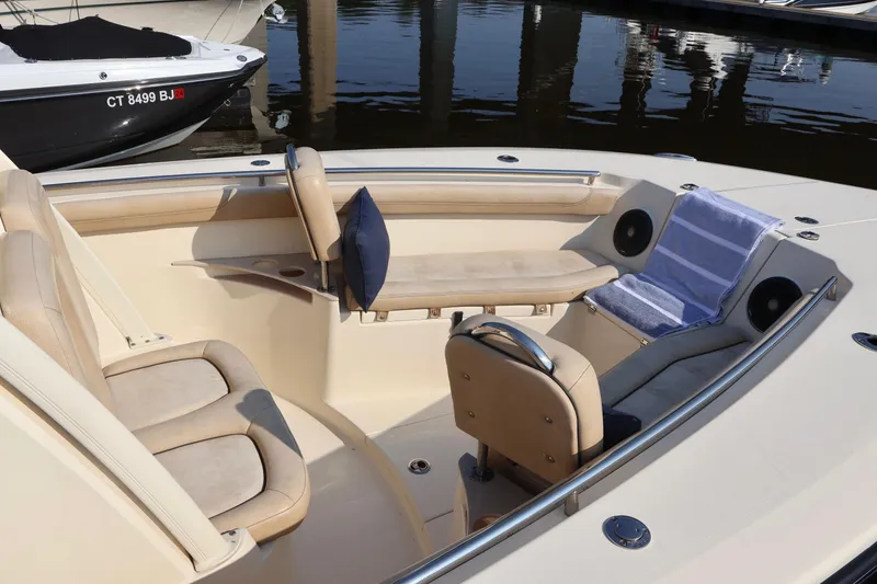 Slide: The Image of 2016 Scout 255 LXF boat interior with beige seating and blue accents. - 21