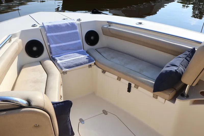 Slide: The Image of 2016 Scout 255 LXF boat interior with seating, cushions, and speakers. - 22