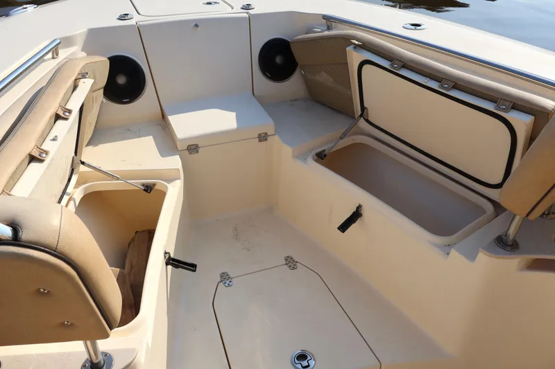 Slide: The Image of 2016 Scout 255 LXF boat interior with storage compartments and seating. - 23