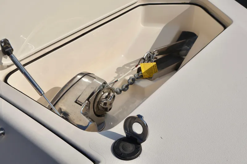Slide: The Image of 2016 Scout 255 LXF boat anchor compartment with chain and lock. - 26