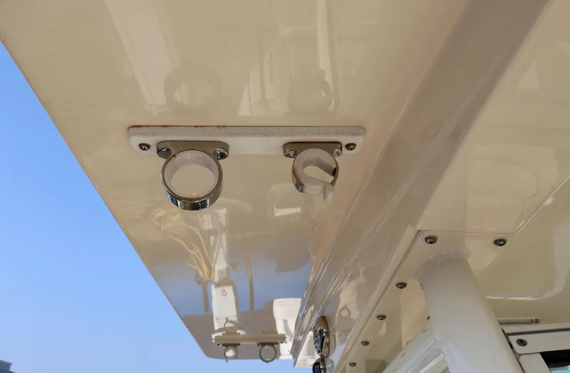 Slide: The Image of 2016 Scout 255 LXF boat detail showing rod holders under hardtop. - 29