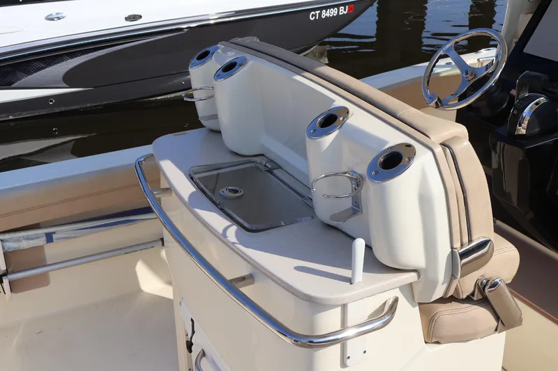 Slide: The Image of 2016 Scout 255 LXF boat interior with seating and cup holders. - 30