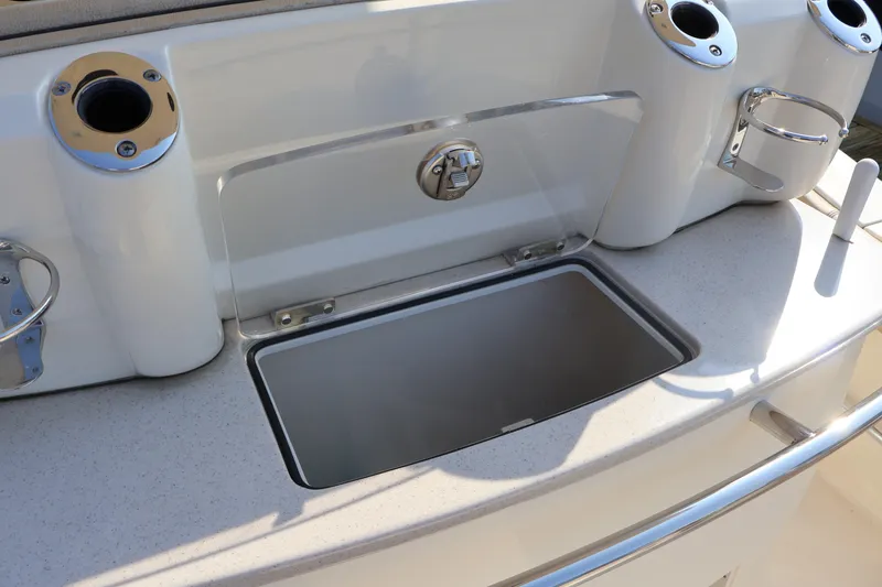 Slide: The Image of 2016 Scout 255 LXF boat with rod holders and storage compartment. - 32