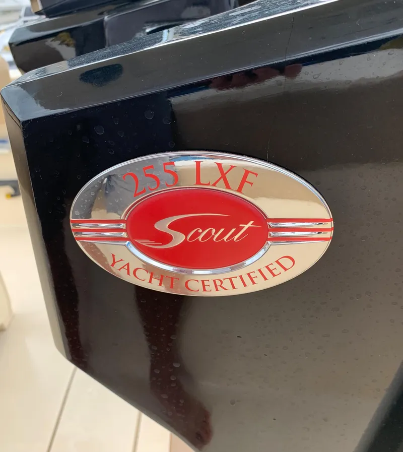 Slide: The Image of 2016 Scout 255 LXF Yacht Certified emblem on black surface. - 33
