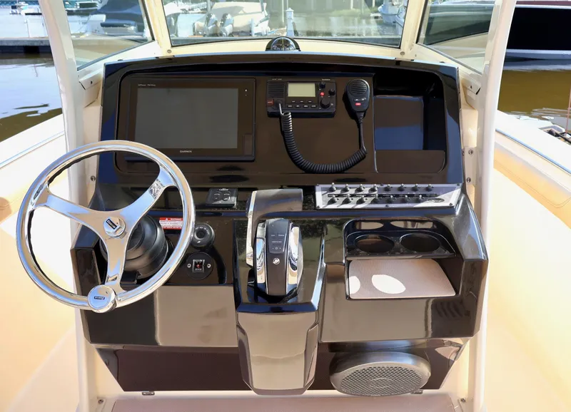 Slide: The Image of 2016 Scout 255 LXF boat dashboard with steering wheel and navigation controls. - 5