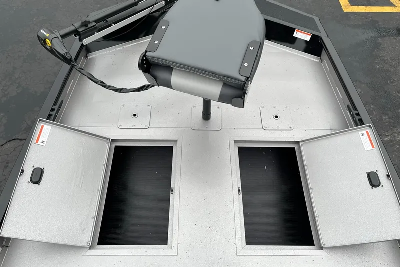 Slide: The Image of 2024 Lowe Legacy boat deck with open storage compartments and seat. - 13