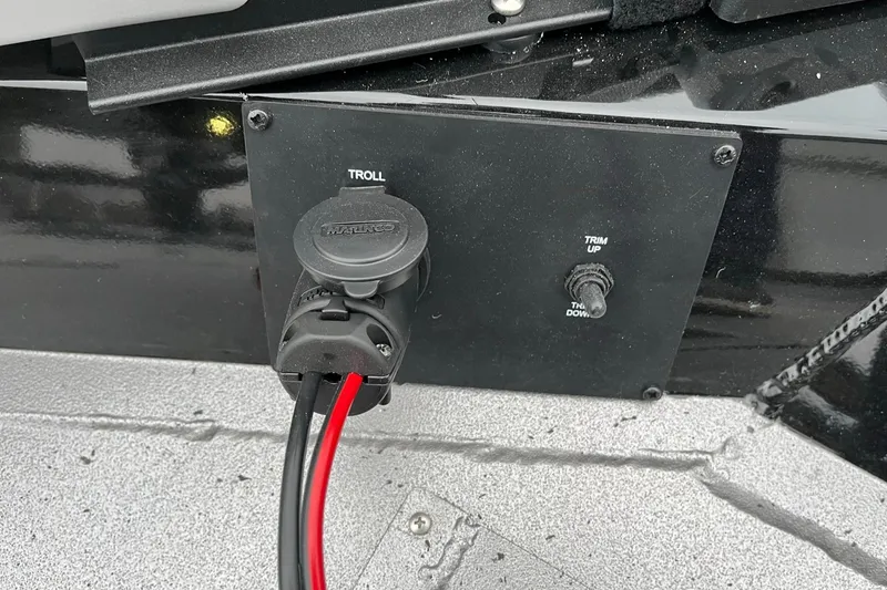 Slide: The Image of 2024 Lowe Legacy trolling motor plug and trim control panel. - 15