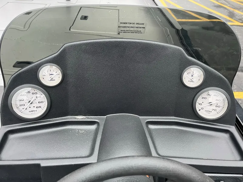 Slide: The Image of Dashboard of 2024 Lowe Legacy boat with gauges and steering wheel. - 16
