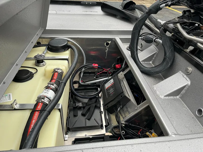 Slide: The Image of 2024 Lowe Legacy boat engine compartment with wiring and fuel system components. - 17