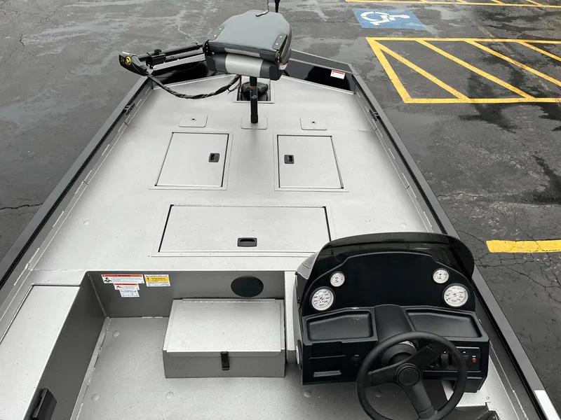 Slide: The Image of 2024 Lowe Legacy boat interior with steering console and storage compartments. - 5