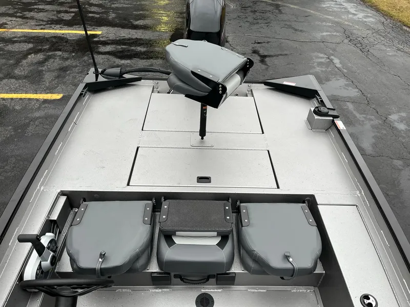 Slide: The Image of 2024 Lowe Legacy boat interior with gray seating and storage compartments. - 9