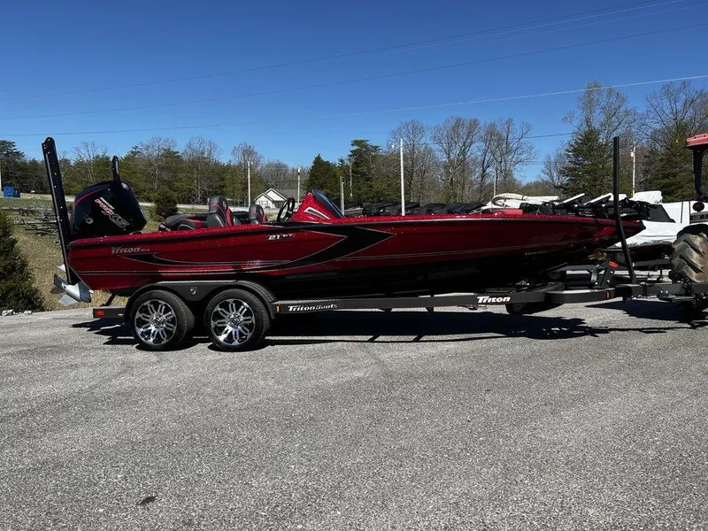 The Image of 2022 Triton 21 XrT bass boat on a trailer in a parking lot. - 1