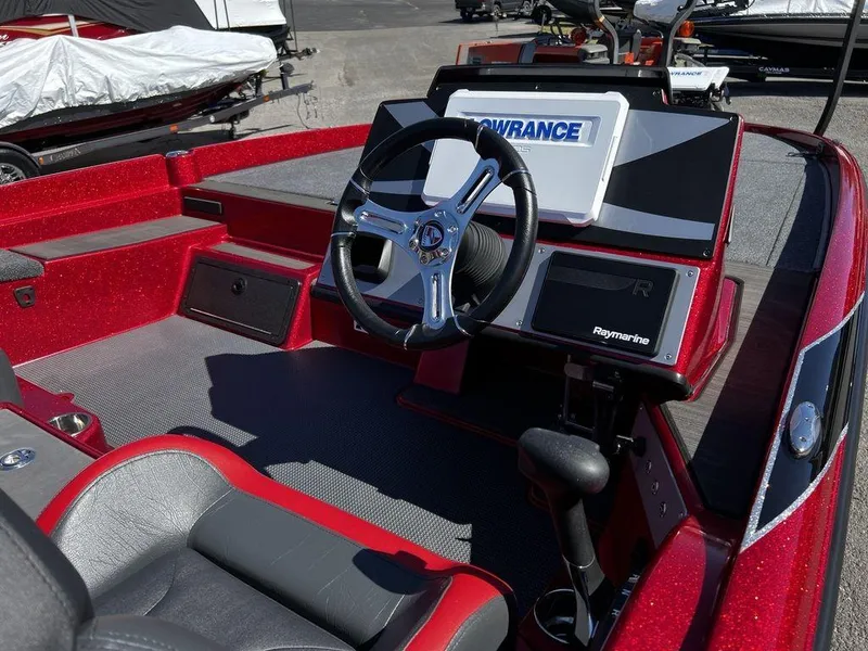 Slide: The Image of 2022 Triton 21 XrT boat interior with steering wheel and navigation system. - 17