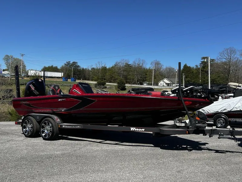 Slide: The Image of 2022 Triton 21 XrT bass boat on a trailer in a parking lot. - 4