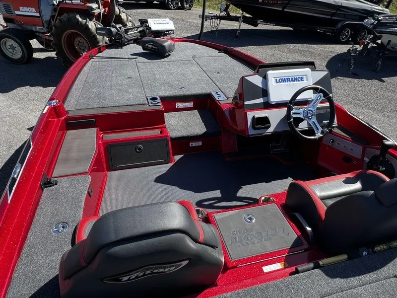 Slide: The Image of 2022 Triton 21 XrT boat interior with Lowrance electronics and red accents. - 5