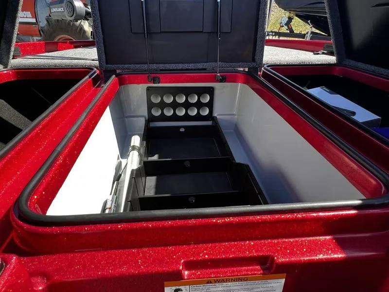 Slide: The Image of 2022 Triton 21 XrT boat storage compartment with rod holders and tackle trays. - 9
