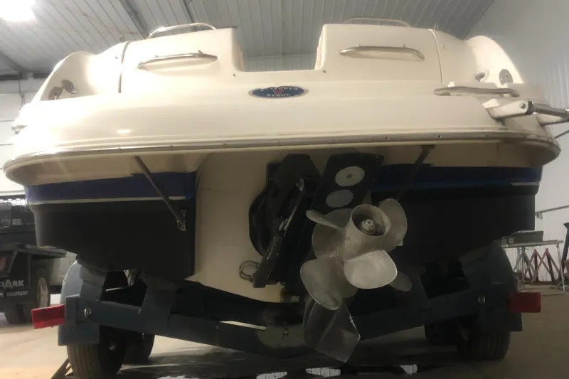 Slide: The Image of Rear view of a 2004 Chaparral 274 SUNESTA boat in a garage. - 10
