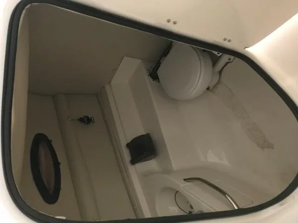 Slide: The Image of 2004 Chaparral 274 SUNESTA boat interior bathroom with toilet and porthole window. - 3