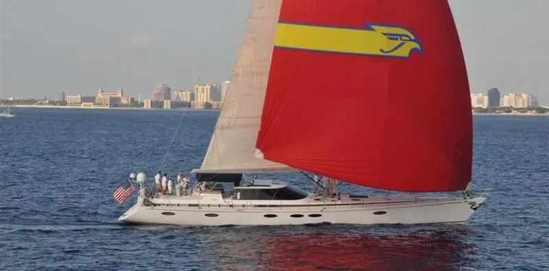 Slide: The Image of Sailing yacht "Able Custom 97'" 1993 with red sail on open water. - 1