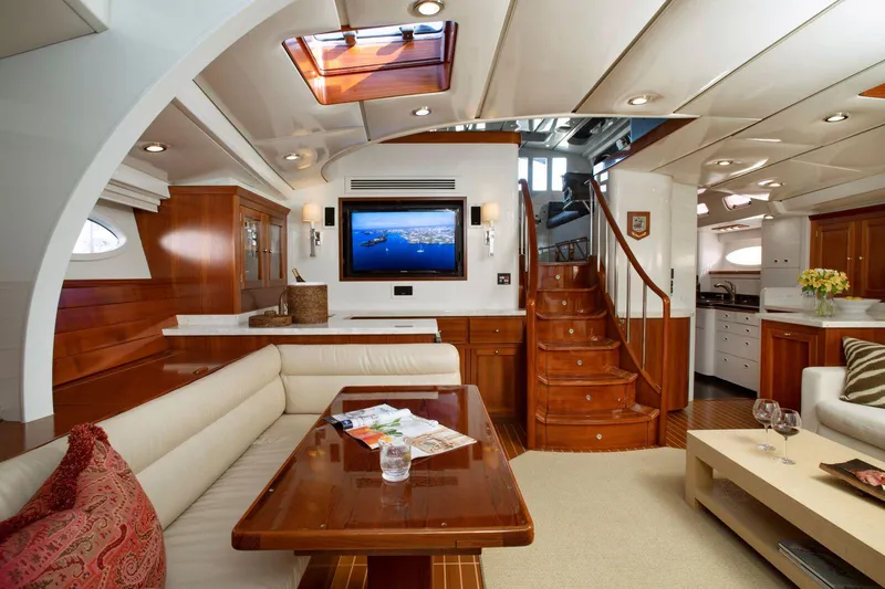 Slide: The Image of Luxurious yacht interior with wooden finishes, cozy seating, and a flat-screen TV. - 11