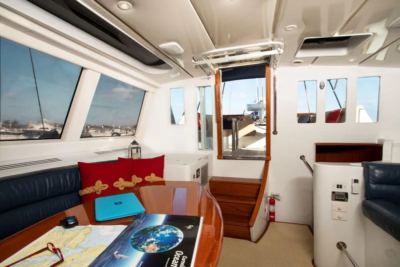 Slide: The Image of Luxurious interior of 1993 Able Custom 97' yacht with navigation table and seating. - 17
