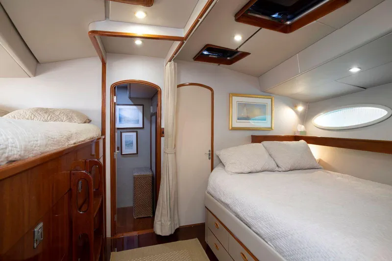 Slide: The Image of Luxurious cabin interior of 1993 Able Custom 97' yacht with cozy bed and elegant decor. - 19