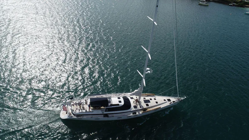 Slide: The Image of Aerial view of 1993 Able Custom 97' yacht sailing on shimmering water. - 2
