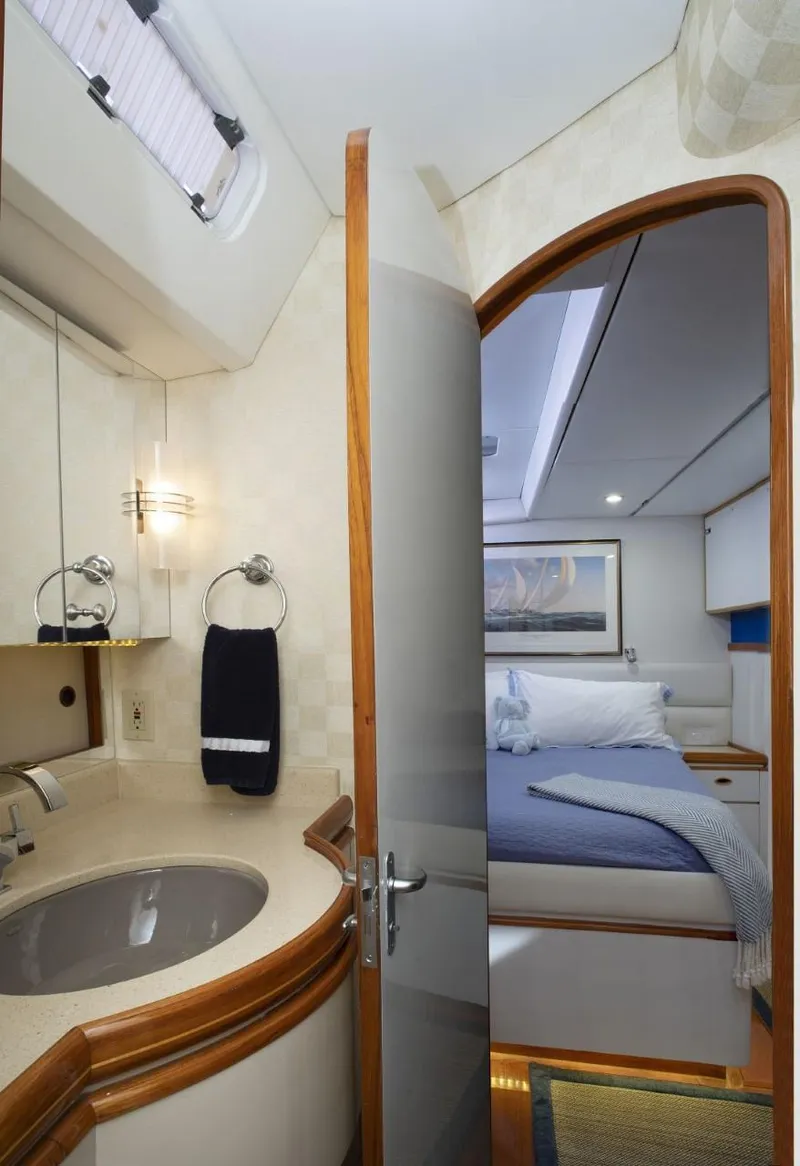 Slide: The Image of Luxurious cabin interior of 1993 Able Custom 97' yacht with cozy bed and modern bathroom. - 21
