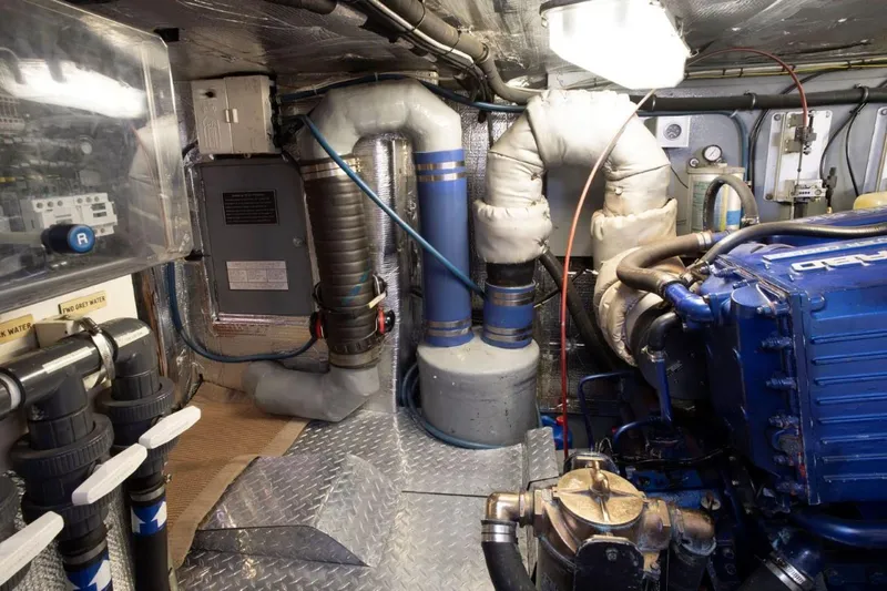 Slide: The Image of Engine room of a 1993 Able Custom 97' boat with visible machinery and piping. - 23