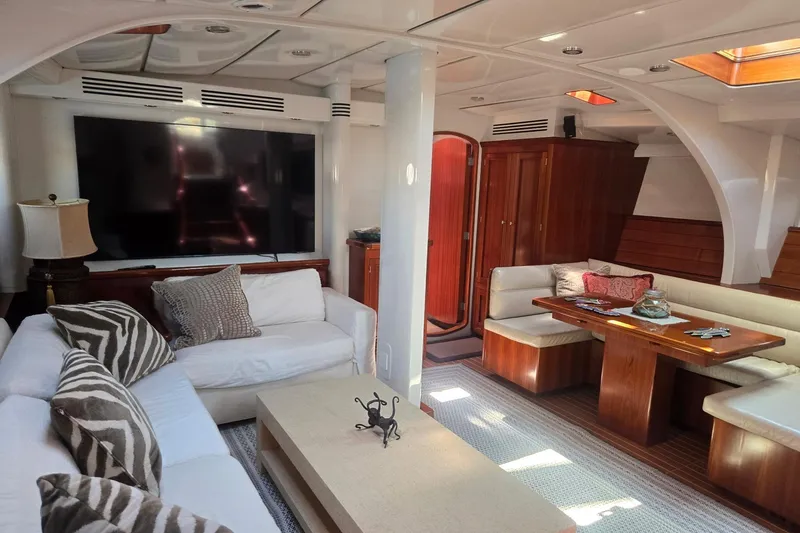 Slide: The Image of Luxurious yacht interior with cozy seating, large TV, and elegant wooden furnishings. - 27