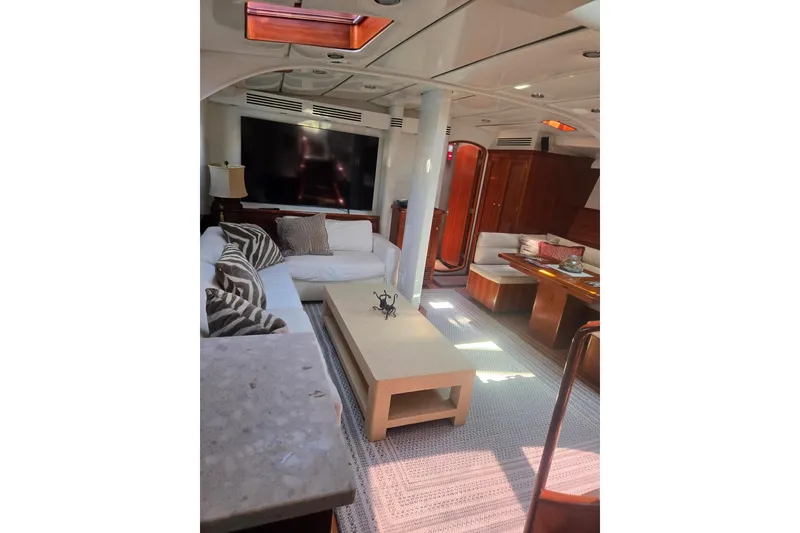 Slide: The Image of Luxurious yacht interior with cozy seating, wooden accents, and modern amenities, Able Custom 97', 1993. - 28