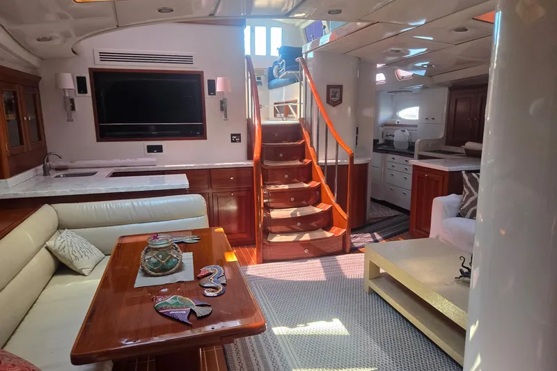 Slide: The Image of Luxurious interior of a 1993 Able Custom 97' yacht with elegant wood finishes and modern amenities. - 31
