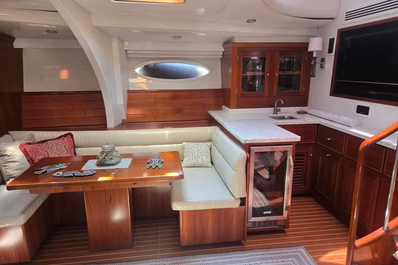 Slide: The Image of Luxurious yacht interior with wooden cabinetry, dining area, and kitchenette, Able Custom 97', 1993. - 34