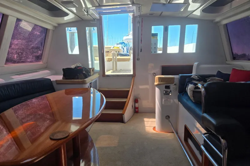Slide: The Image of Interior of a 1993 Able Custom 97' yacht with elegant seating and wooden table. - 35