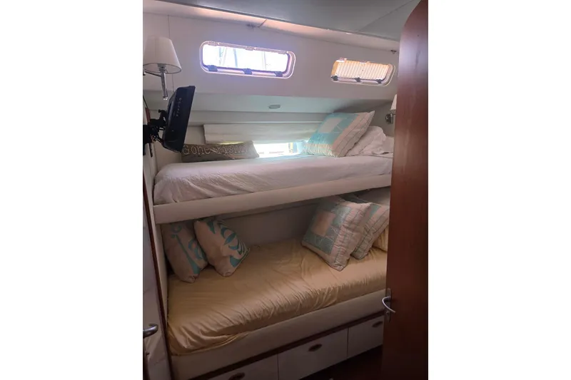 Slide: The Image of Bunk beds in a 1993 Able Custom 97' yacht cabin with cozy pillows and natural light. - 38
