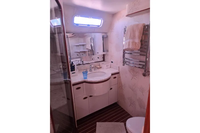 Slide: The Image of Luxurious yacht bathroom with elegant fixtures, towel rack, and vanity mirror, aboard Able Custom 97', 1993. - 40