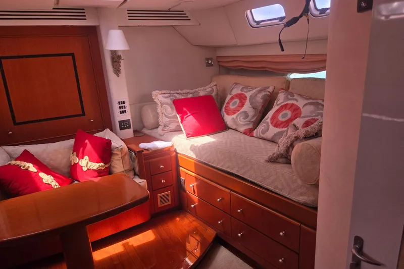Slide: The Image of Luxurious cabin interior of 1993 Able Custom 97' yacht with plush seating and vibrant cushions. - 43
