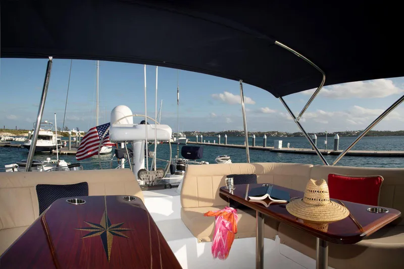 Slide: The Image of Luxurious Able Custom 97' yacht deck with seating, table, and ocean view. - 5