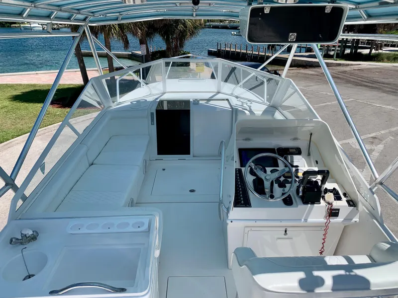 Slide: The Image of 2003 Contender 35 Express Side Console boat interior with helm and seating area. - 12