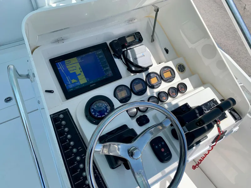 Slide: The Image of 2003 Contender 35 Express Side Console dashboard with navigation and control instruments. - 13