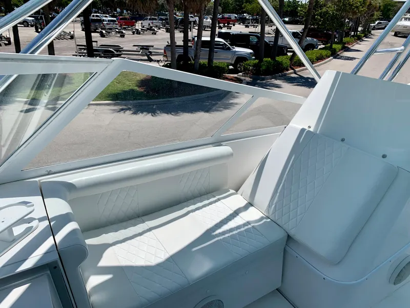 Slide: The Image of 2003 Contender 35 Express Side Console boat with white seating and clear windshield. - 14