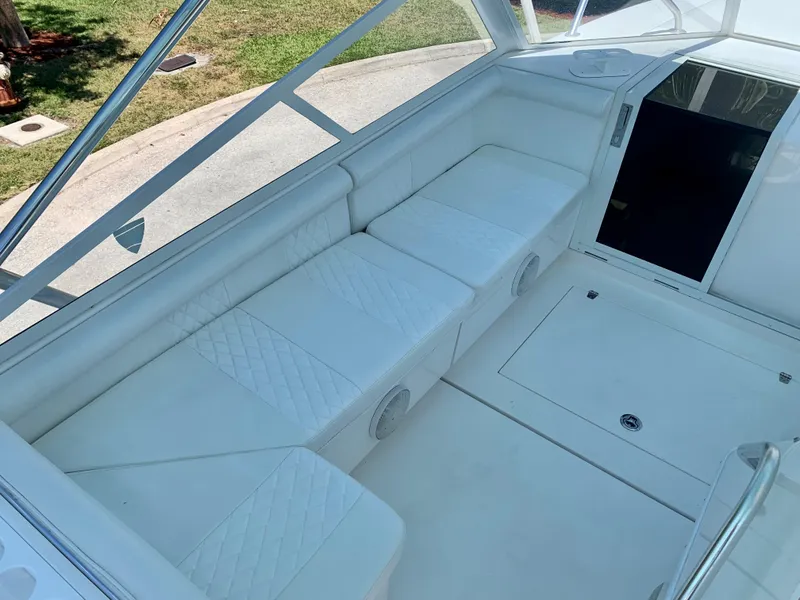 Slide: The Image of 2003 Contender 35 Express Side Console with white cushioned seating. - 15