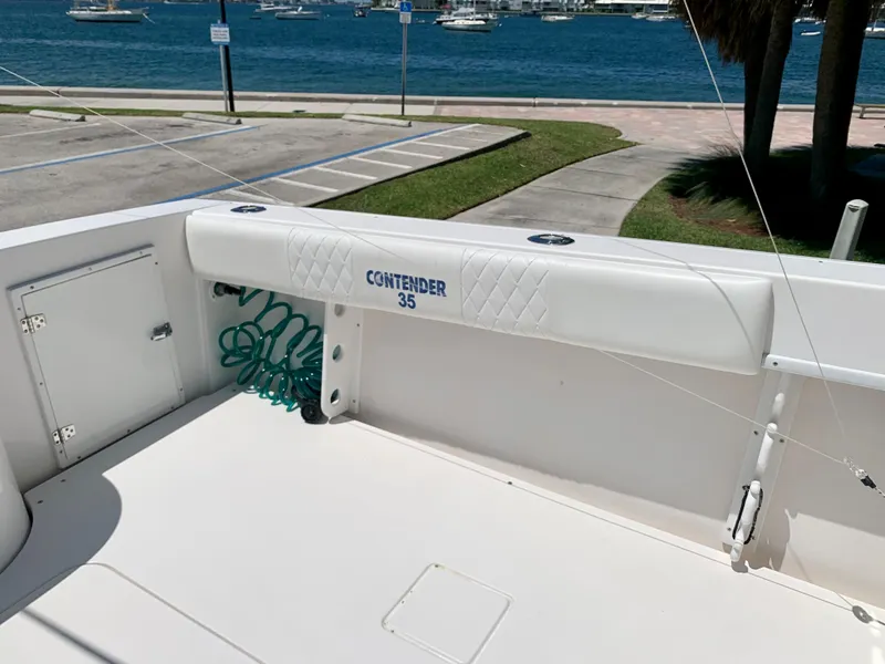 Slide: The Image of 2003 Contender 35 Express Side Console boat docked near the water. - 16
