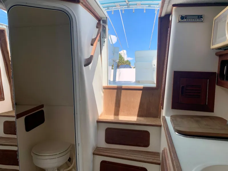 Slide: The Image of Interior of 2003 Contender 35 Express Side Console boat with steps and toilet. - 22