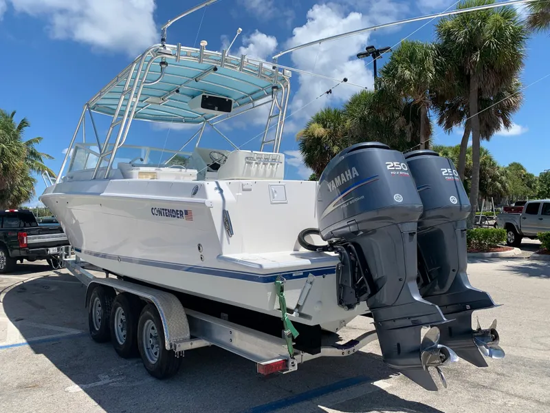 Slide: The Image of 2003 Contender 35 Express Side Console boat with twin Yamaha 250 engines on trailer. - 26