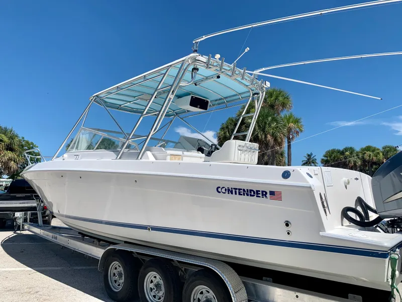 Slide: The Image of 2003 Contender 35 Express Side Console boat on a trailer. - 29