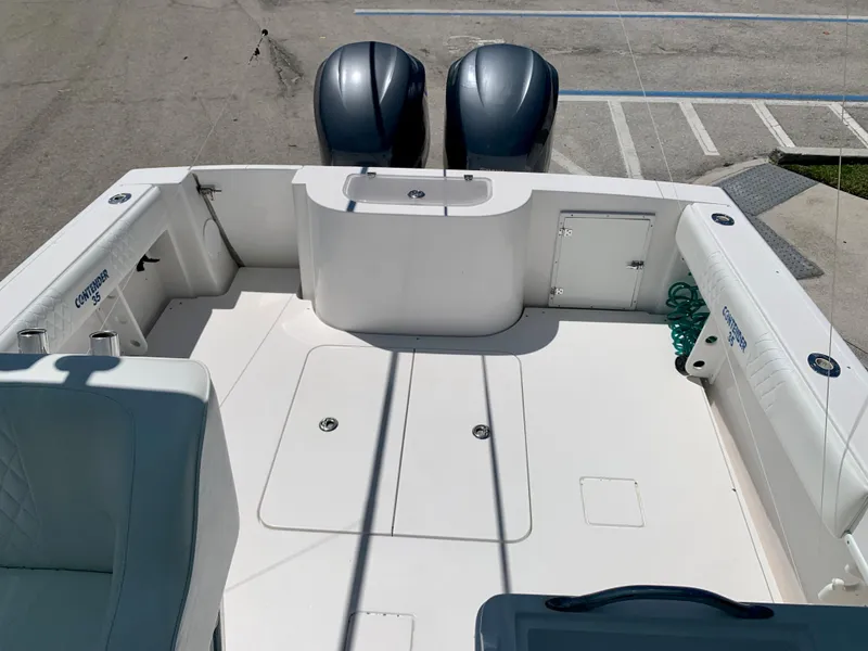 Slide: The Image of 2003 Contender 35 Express Side Console boat with twin outboard engines. - 32