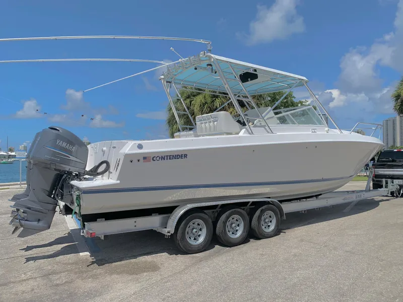 Slide: The Image of 2003 Contender 35 Express Side Console boat on a trailer with Yamaha outboard engines. - 6
