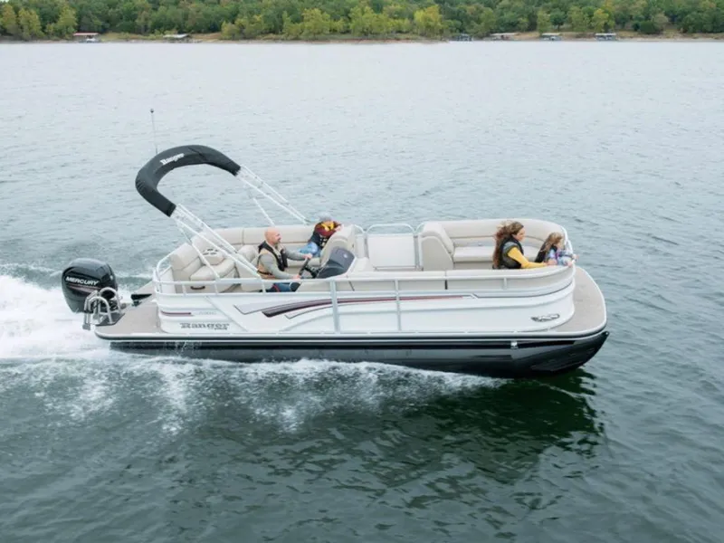 The Image of 2023 Ranger 220C pontoon boat cruising on a lake with passengers. - 1
